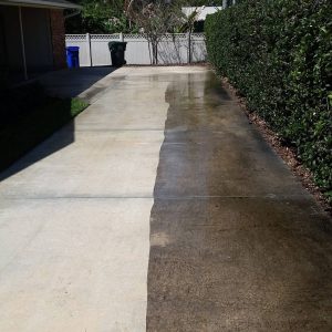 pressure washed driveway with half dirty
